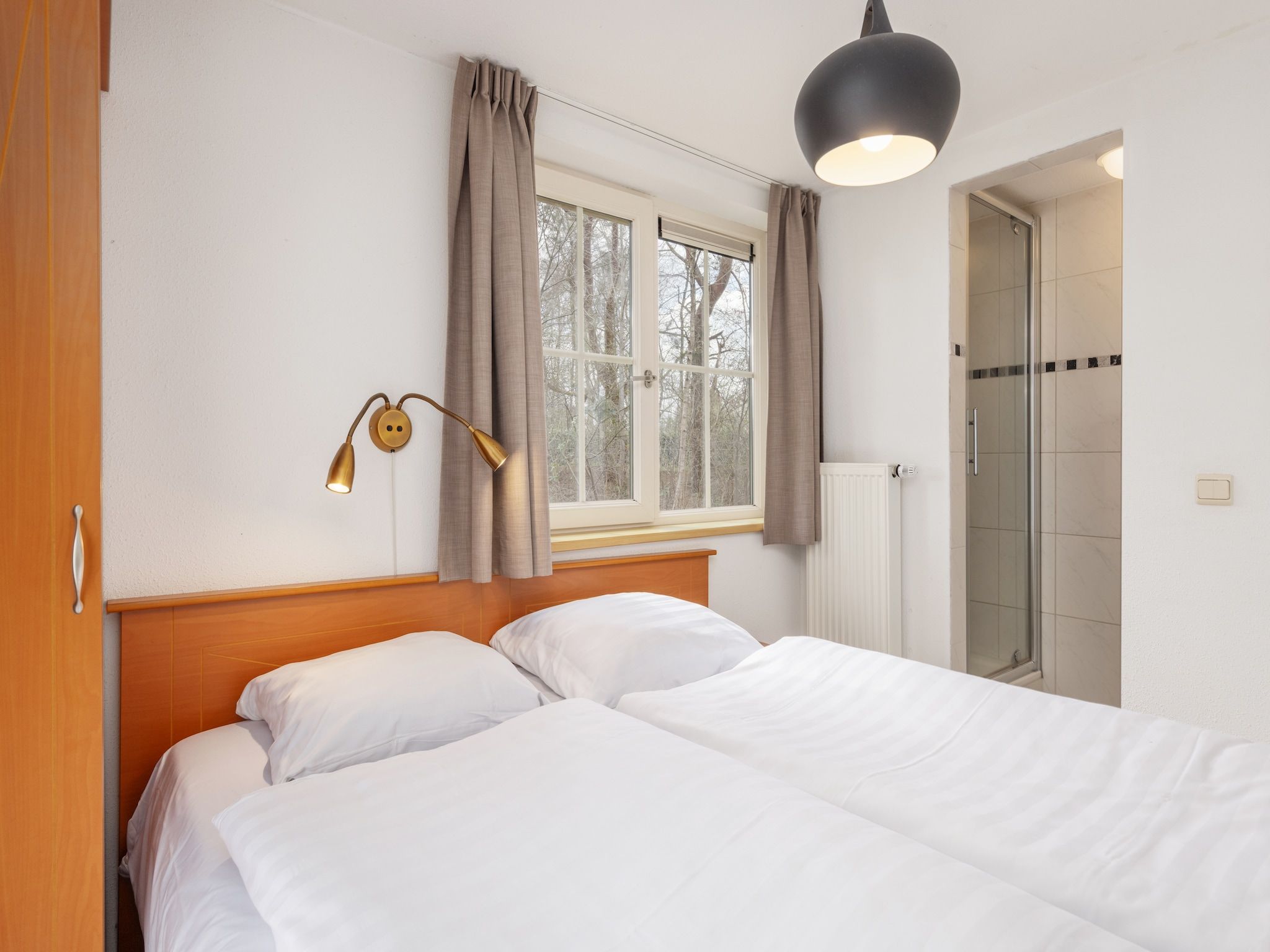 Een slaapkamer van De Veluwse Hoevegaerde 2 in Putten