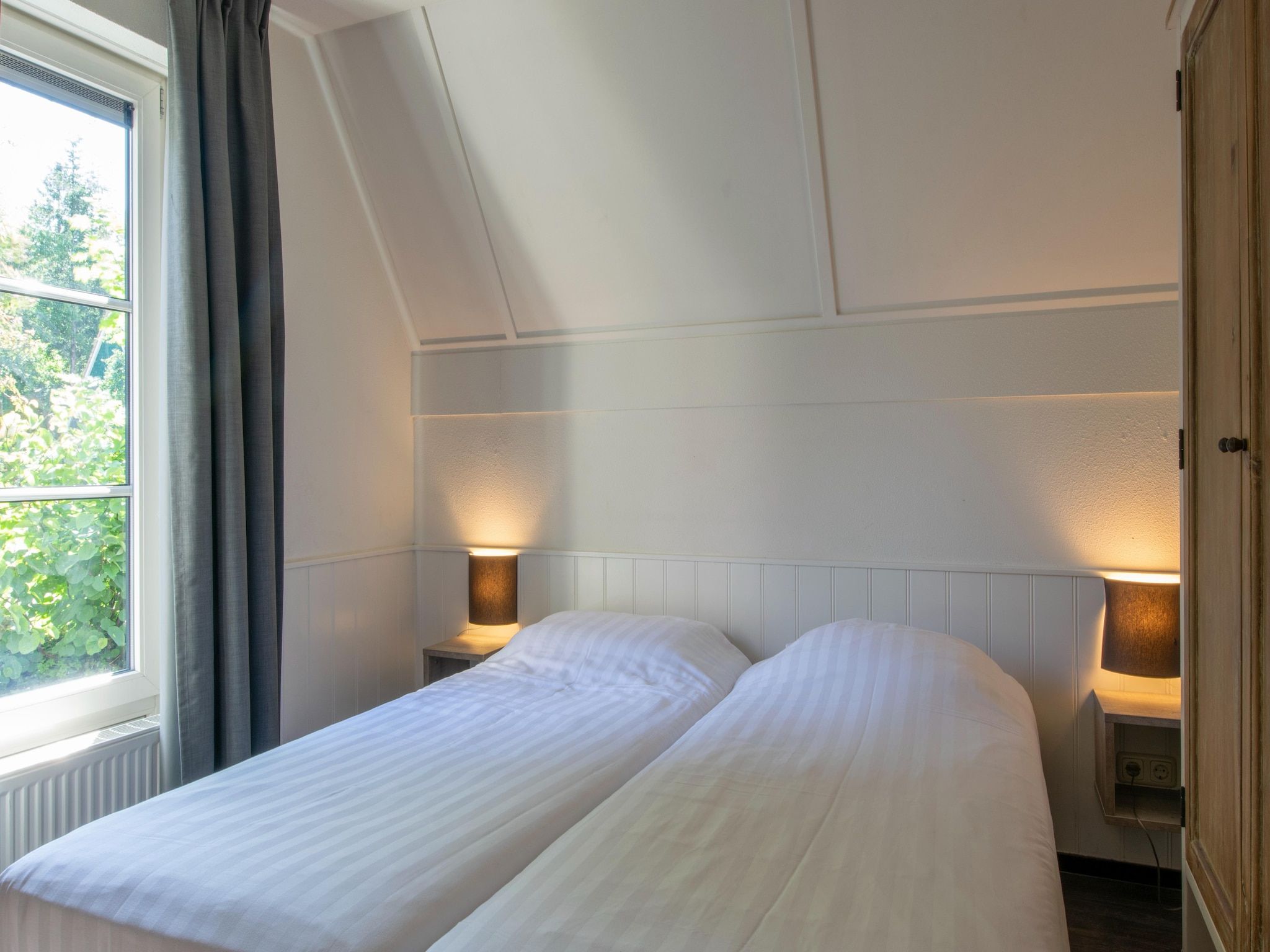 Een slaapkamer van Vakantiepark de Katjeskelder 18 in Oosterhout