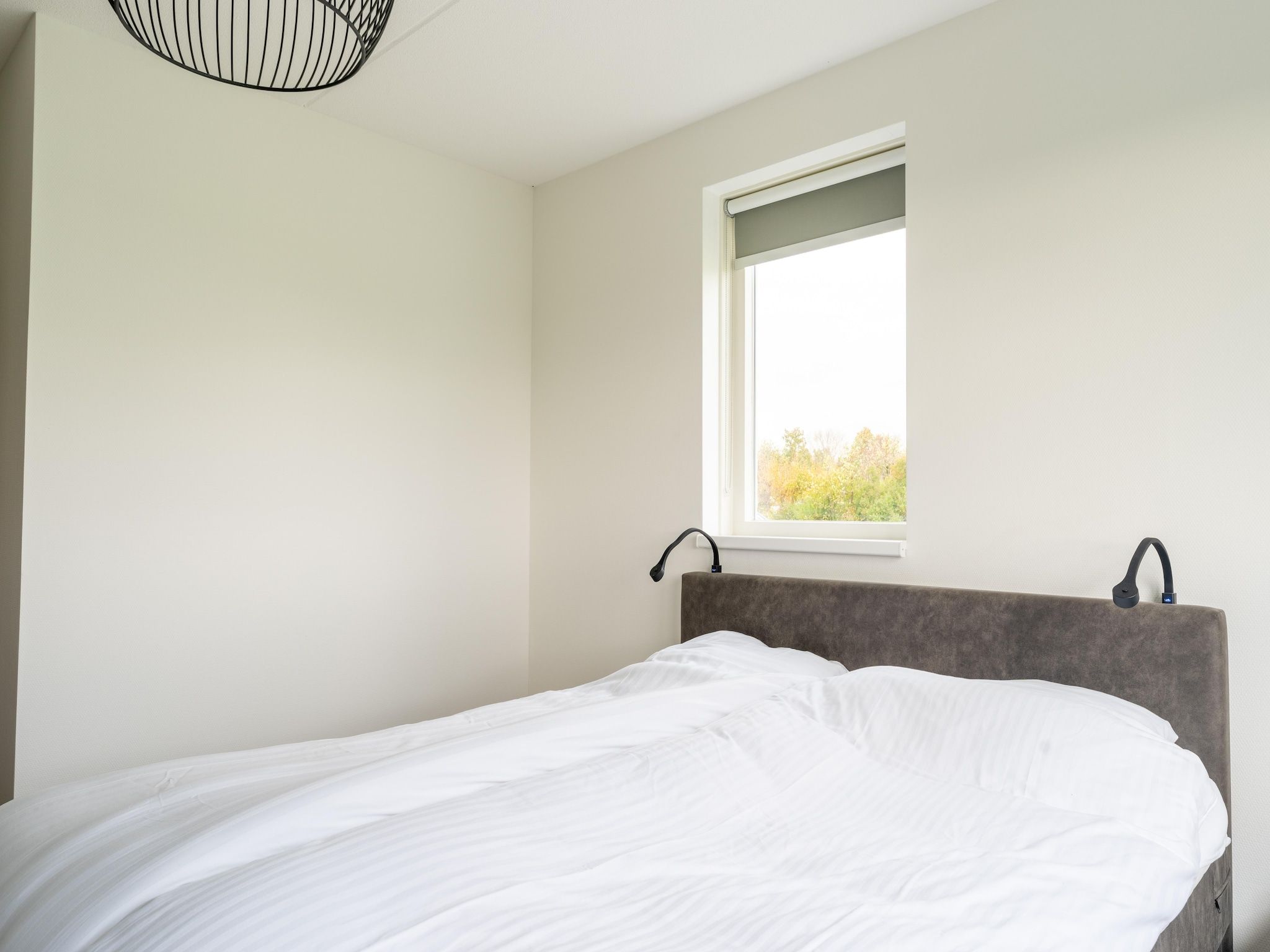 Een slaapkamer van De Kokmeeuw Huis Nr 11 in Scherpenisse