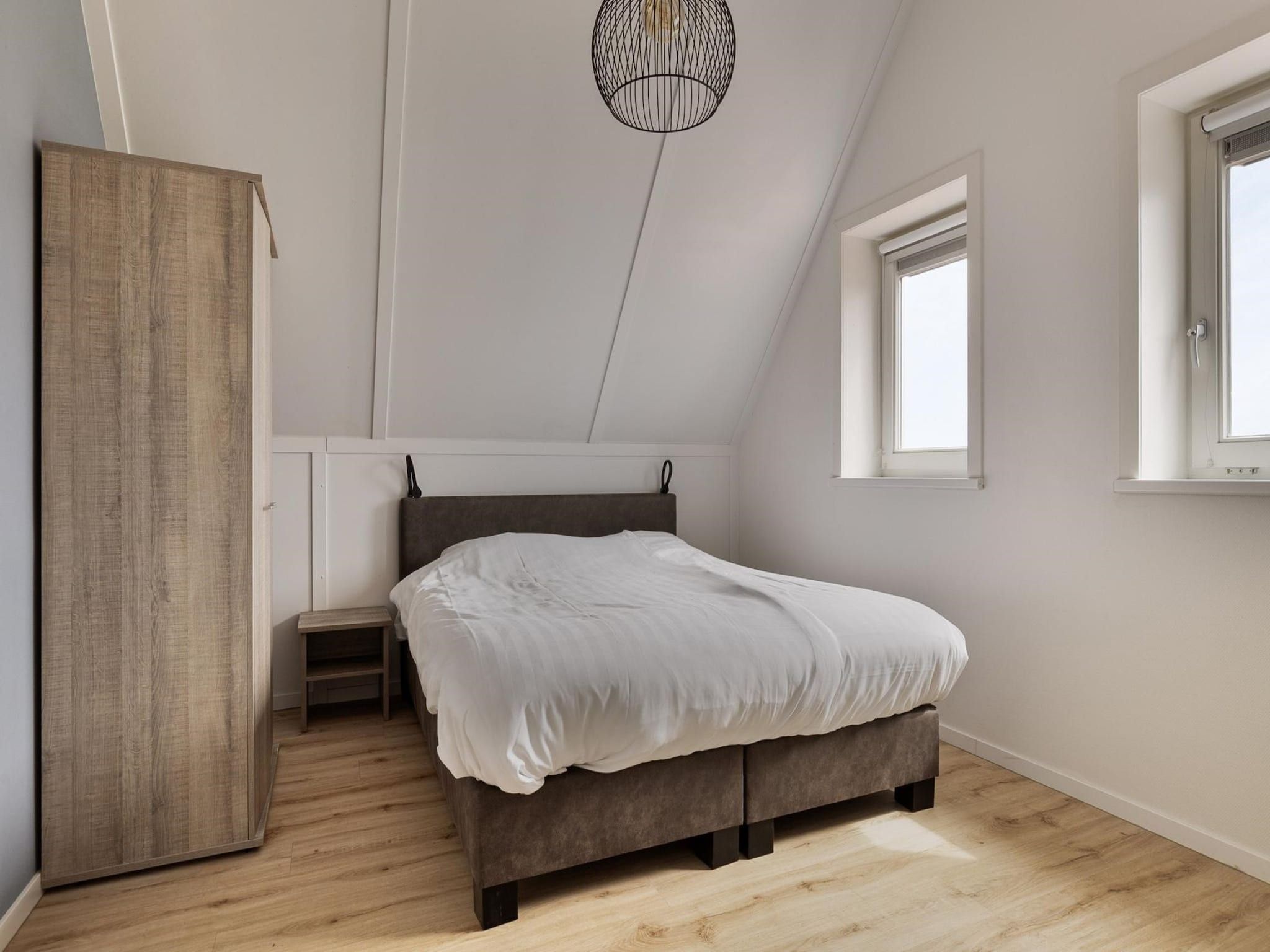 Een slaapkamer van De Ooievaar Huis Nr 47 in Scherpenisse