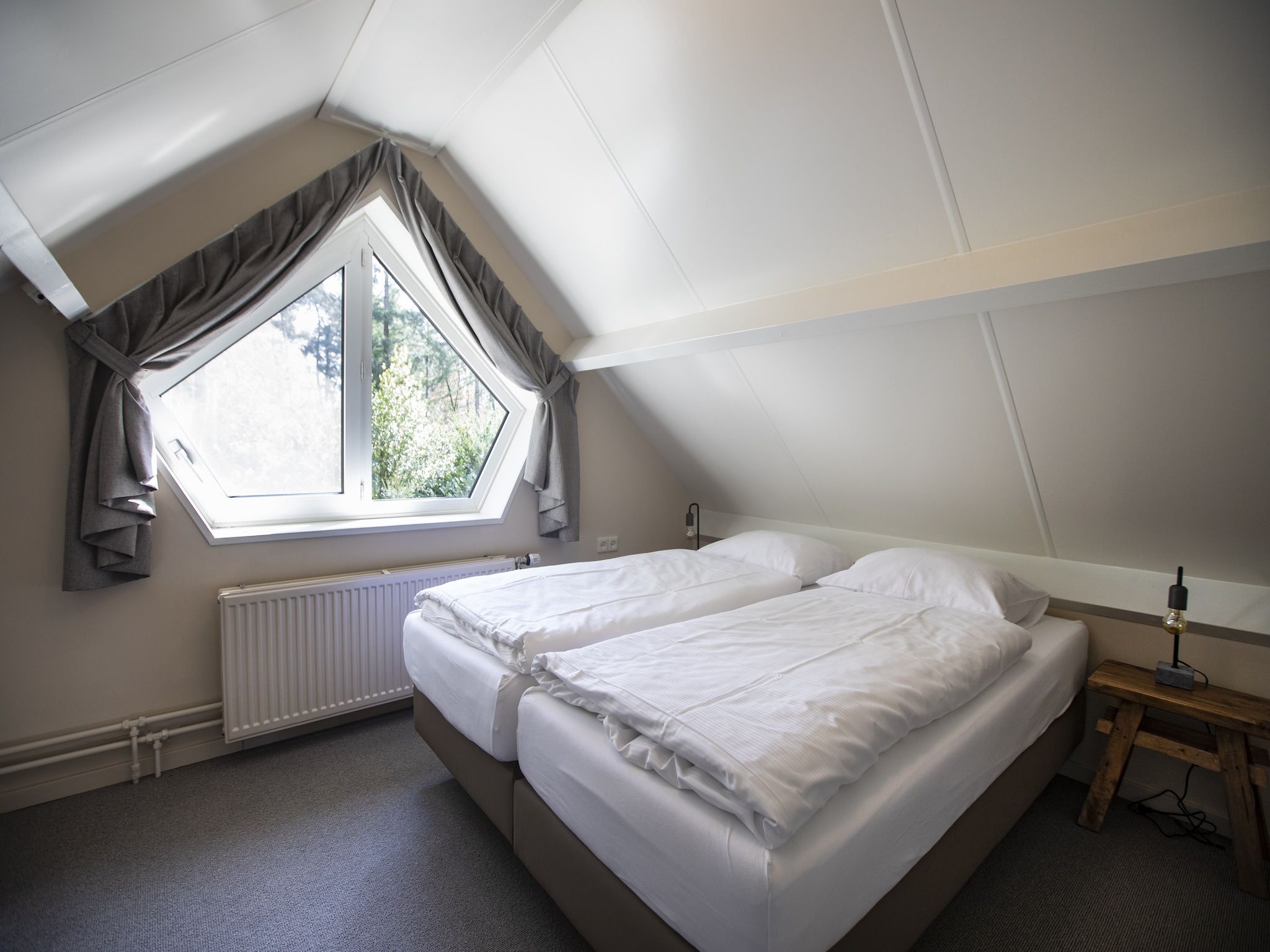 Een slaapkamer van Vakantie bij Meeussen - Schuttersoord 3 in Mook