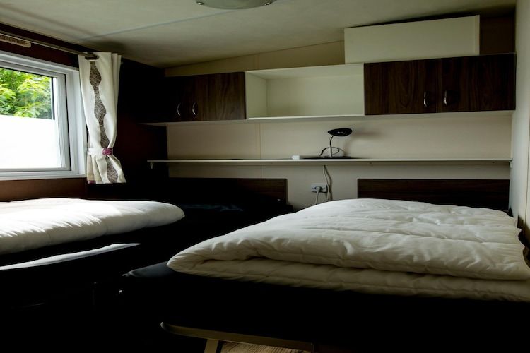 Een slaapkamer van Recreatiepark Duinhoeve 11 in Udenhout