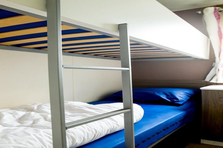 Een slaapkamer van Recreatiepark Duinhoeve 11 in Udenhout