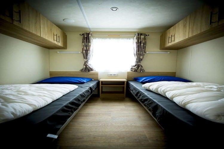 Een slaapkamer van Recreatiepark Duinhoeve 9 in Udenhout
