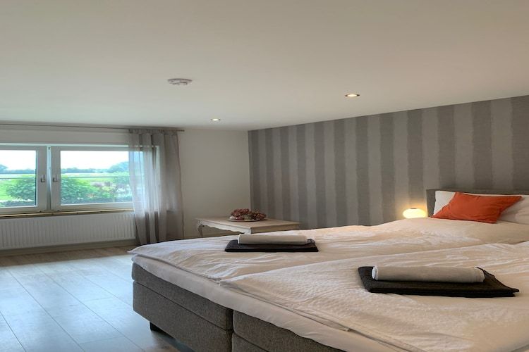 Een slaapkamer van Villa Grenszicht in Megchelen