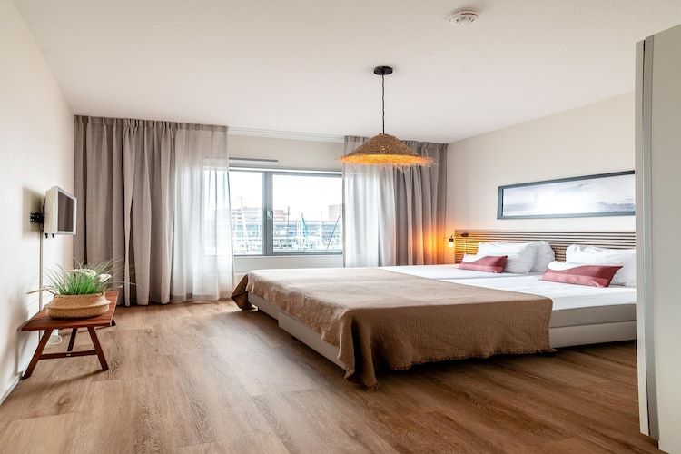 Een slaapkamer van Scheveningen Harbour 56 in Den Haag