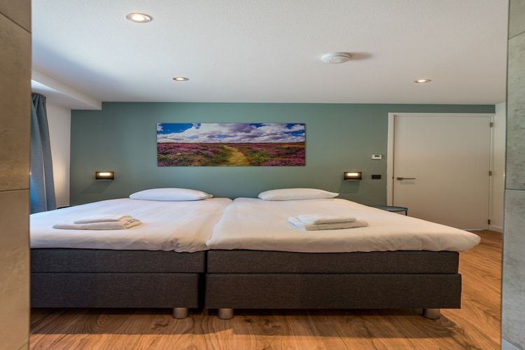 Een slaapkamer van Bruine Kiekendief in Den Burg